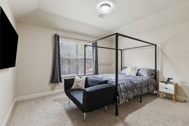 carpeted bedroom featuring baseboards and visible vents