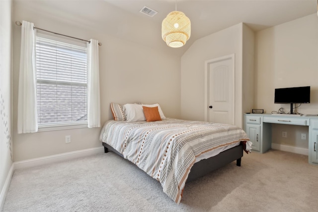 bedroom featuring baseboards, visible vents, and light colored carpet