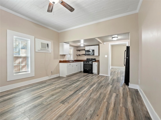 kitchen with ornamental molding, white cabinetry, range, and freestanding refrigerator