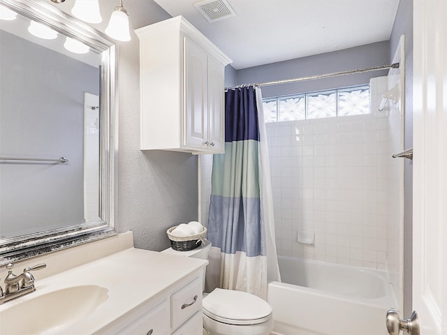 full bath with shower / tub combo, visible vents, a textured wall, toilet, and vanity