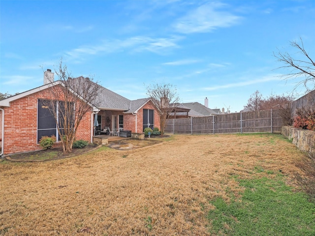 view of yard with a patio area and a fenced backyard