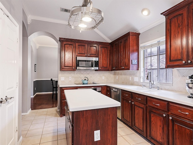 kitchen with light countertops, appliances with stainless steel finishes, a sink, and visible vents