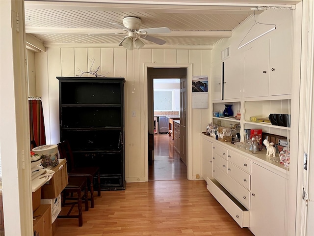 kitchen featuring visible vents, a ceiling fan, wood ceiling, white cabinets, and light wood-style floors