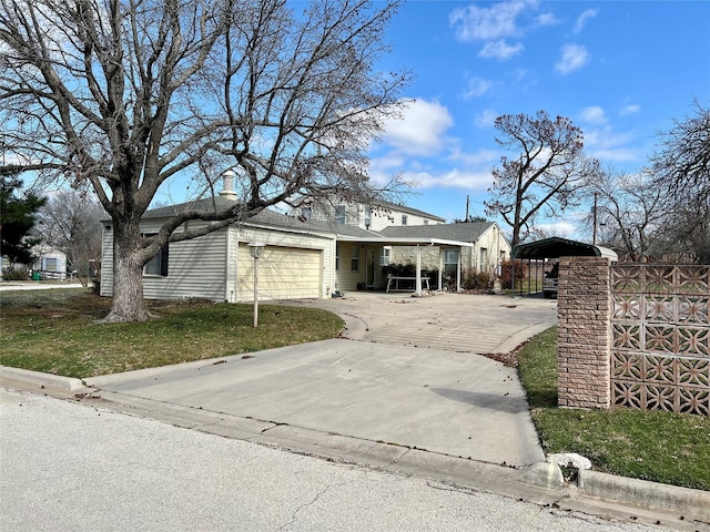 view of front of property with driveway, a chimney, and an attached garage