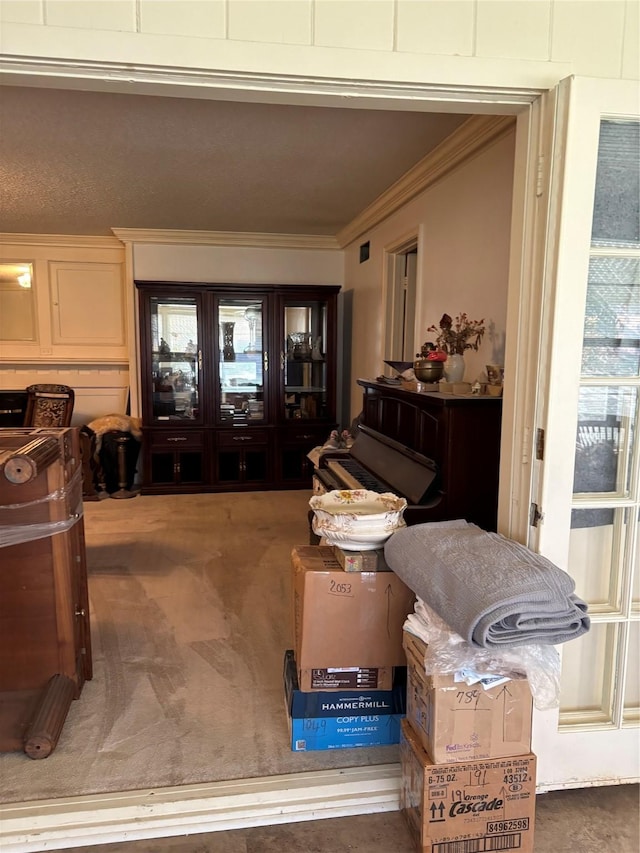 interior space featuring carpet floors and crown molding