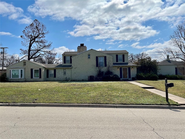 view of front of home featuring a chimney and a front lawn