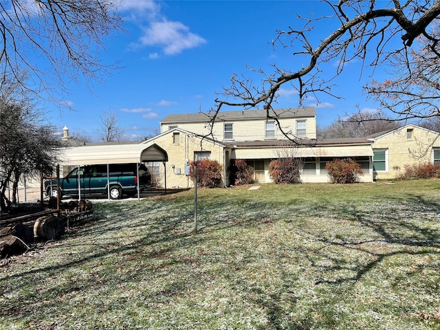 view of front of property with a front lawn and a detached carport