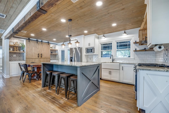 kitchen with white cabinets, open shelves, and a center island