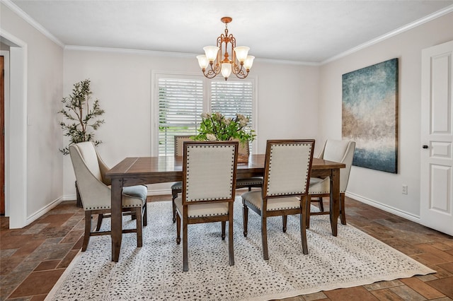 dining area featuring ornamental molding, stone tile flooring, baseboards, and an inviting chandelier