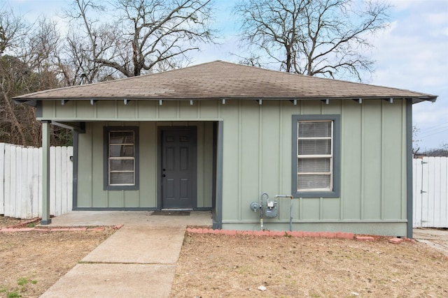 exterior space featuring board and batten siding and fence