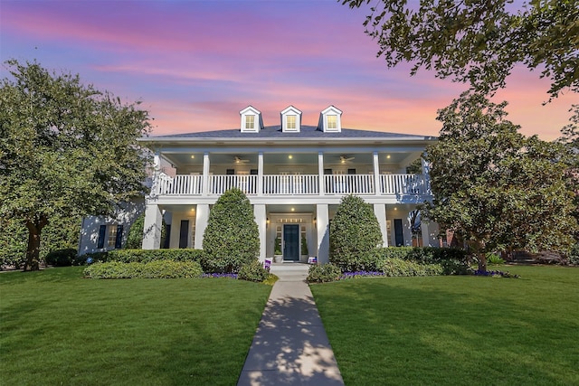 view of front of home featuring a front yard and a balcony