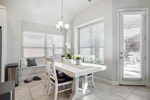 dining area featuring a wealth of natural light, visible vents, vaulted ceiling, and light tile patterned floors