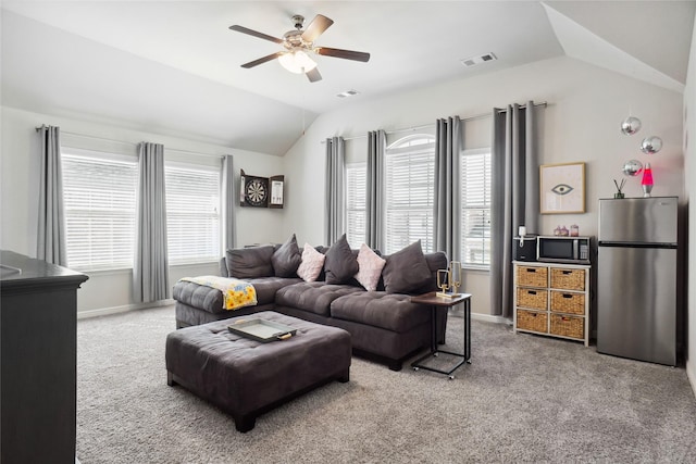 living area featuring ceiling fan, visible vents, baseboards, vaulted ceiling, and carpet