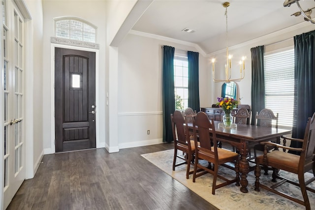 dining area featuring baseboards, dark wood finished floors, visible vents, and a notable chandelier