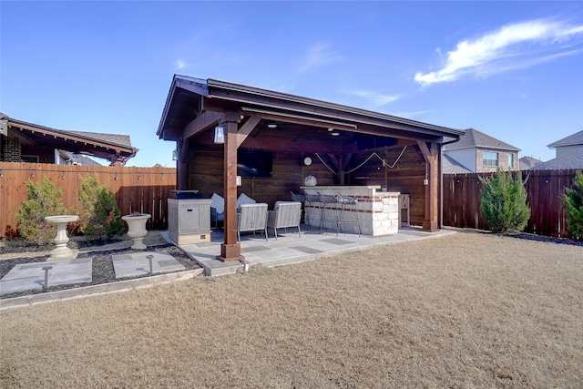 view of patio / terrace with outdoor dry bar and fence