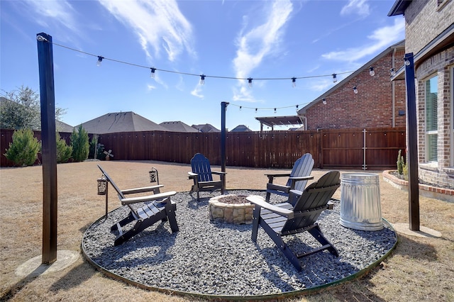 view of patio with a fenced backyard and a fire pit