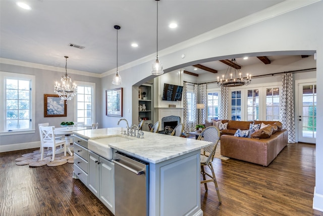 kitchen featuring a center island with sink, open floor plan, a chandelier, pendant lighting, and stainless steel dishwasher