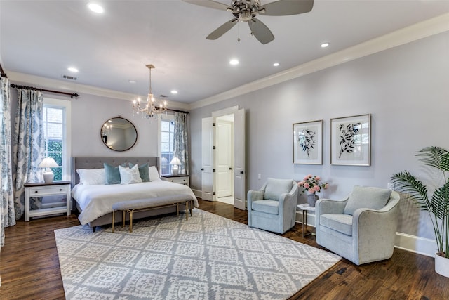 bedroom featuring ornamental molding, multiple windows, wood finished floors, and visible vents