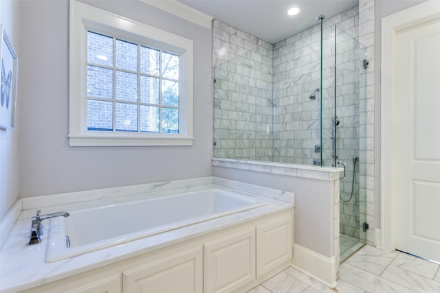 bathroom with a garden tub, marble finish floor, and a stall shower