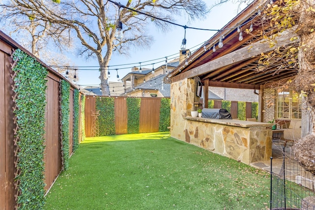 view of yard featuring a fenced backyard and outdoor dry bar