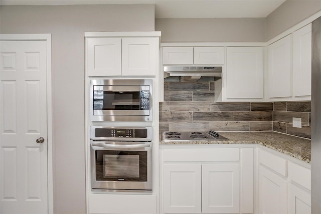 kitchen featuring light stone counters, backsplash, appliances with stainless steel finishes, white cabinets, and under cabinet range hood