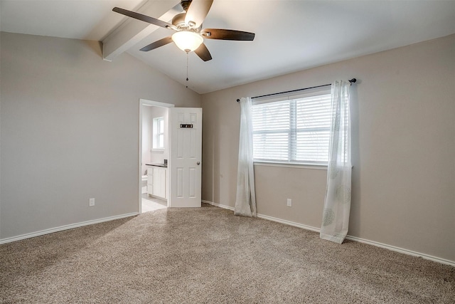 unfurnished room featuring lofted ceiling with beams, carpet, a ceiling fan, and baseboards