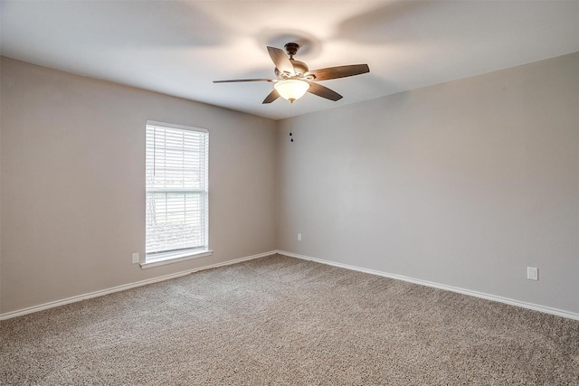 empty room featuring carpet, ceiling fan, and baseboards