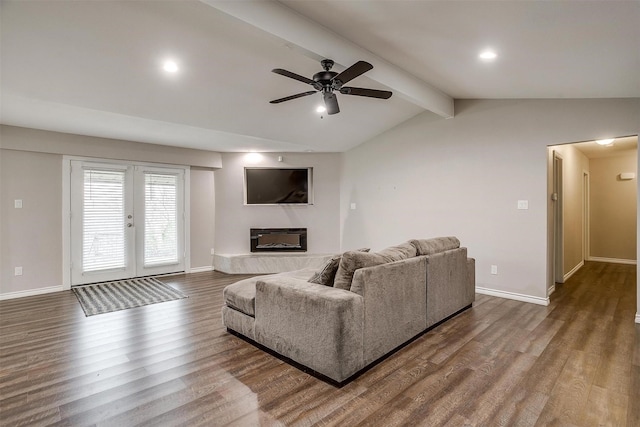 living area with lofted ceiling with beams, baseboards, and wood finished floors