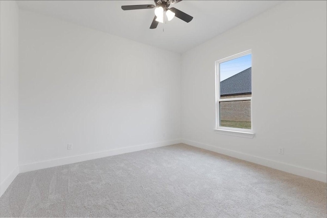 empty room featuring ceiling fan, baseboards, and carpet flooring