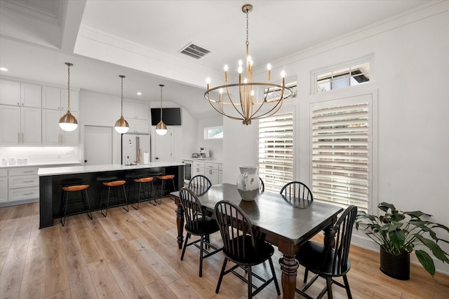 dining area featuring a notable chandelier, visible vents, baseboards, light wood finished floors, and crown molding