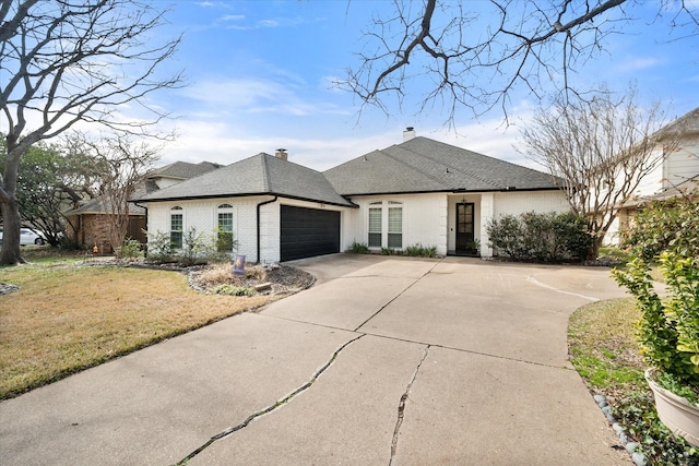 french country style house with an attached garage, brick siding, concrete driveway, roof with shingles, and a front lawn