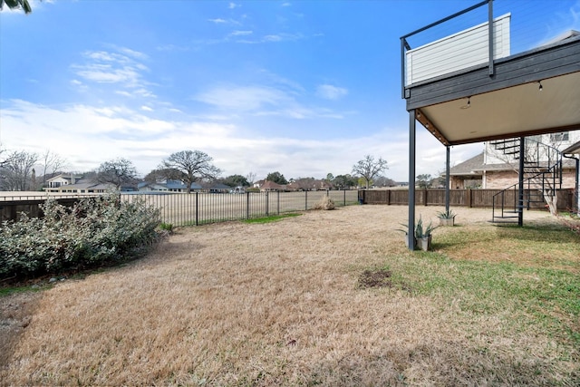 view of yard with stairway and a fenced backyard