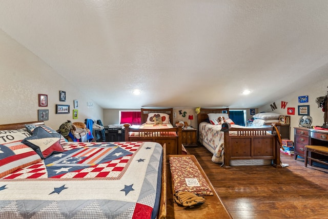 bedroom with lofted ceiling, dark wood-type flooring, and a textured ceiling