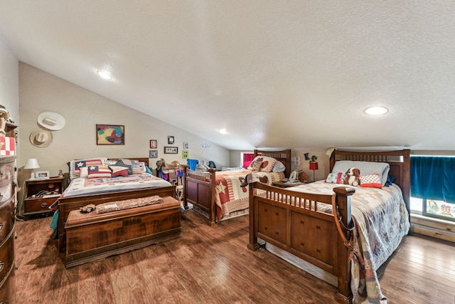 bedroom featuring vaulted ceiling, a textured ceiling, and wood finished floors