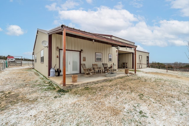 rear view of property with a patio and fence