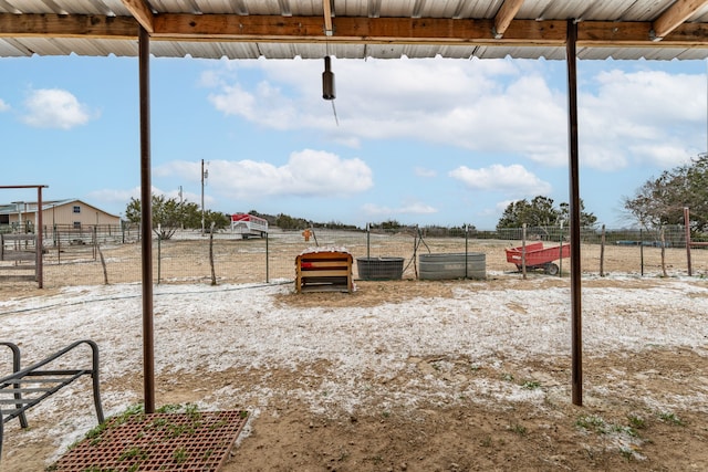 view of yard featuring fence and a rural view