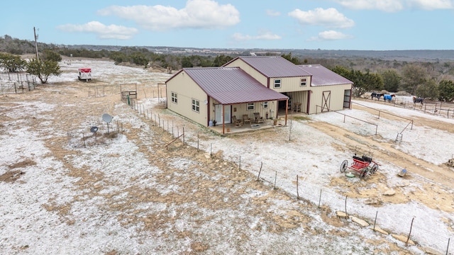 exterior space with fence and metal roof