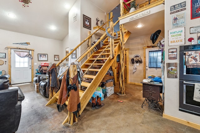 stairway featuring baseboards, visible vents, concrete flooring, and recessed lighting