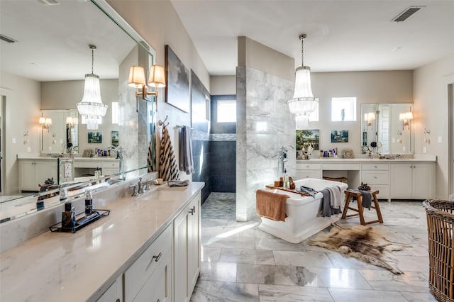 full bath featuring marble finish floor, visible vents, an inviting chandelier, vanity, and walk in shower