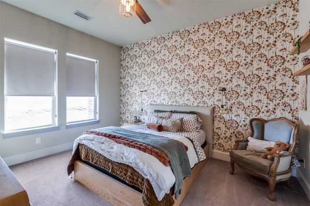 bedroom with carpet, visible vents, baseboards, and wallpapered walls