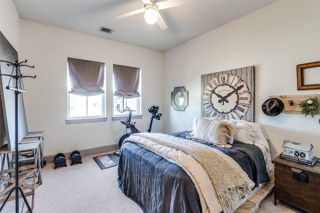 bedroom featuring a ceiling fan, light colored carpet, visible vents, and baseboards