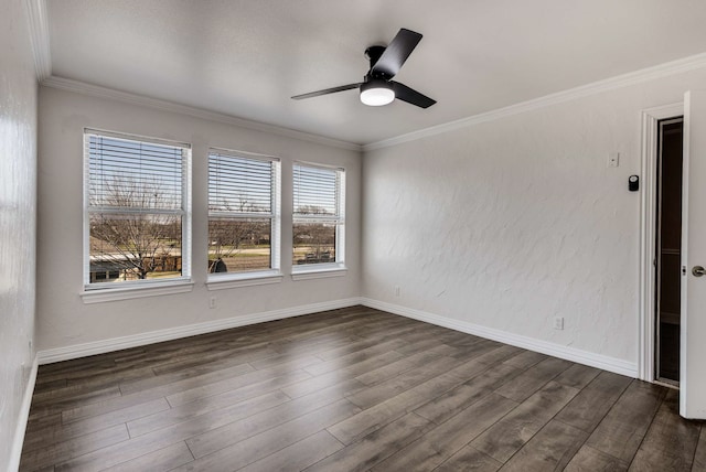 spare room featuring dark wood-type flooring, ornamental molding, baseboards, and a ceiling fan