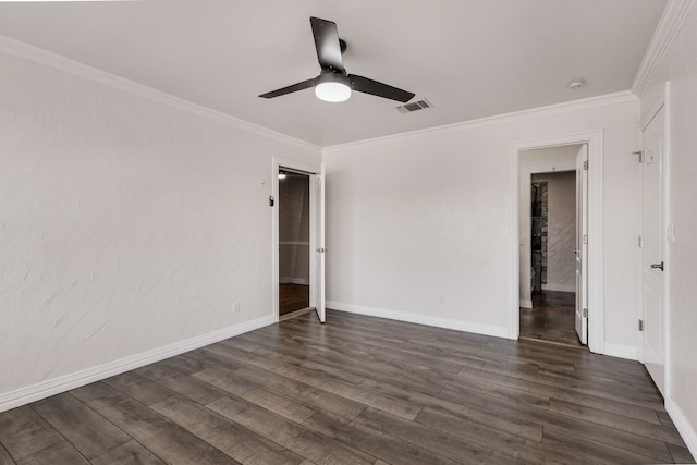 unfurnished room with ornamental molding, visible vents, dark wood finished floors, and baseboards