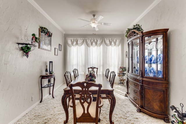 dining room with carpet floors, a textured wall, ceiling fan, and ornamental molding