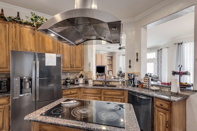 kitchen with island range hood, dark stone counters, appliances with stainless steel finishes, a peninsula, and a sink