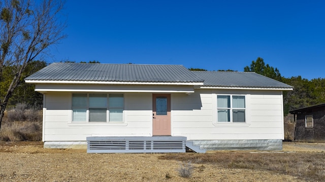 rear view of house with metal roof