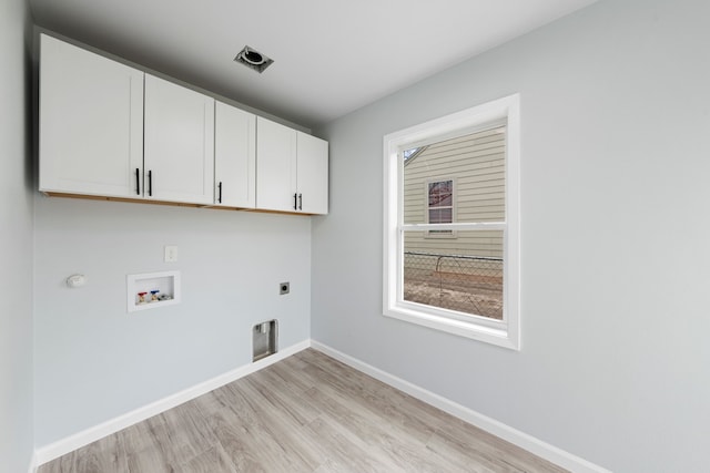 laundry room featuring cabinet space, baseboards, light wood-style flooring, hookup for an electric dryer, and washer hookup