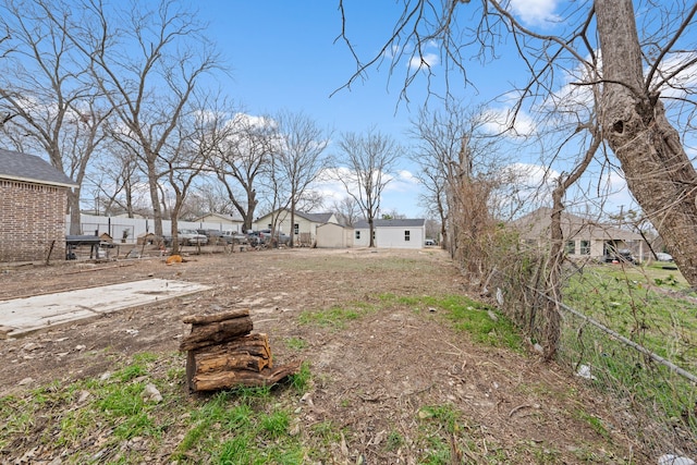 view of yard with a residential view and fence