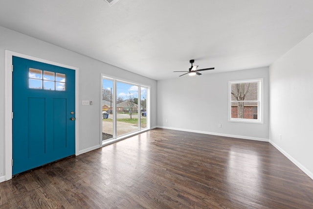 entryway with ceiling fan, baseboards, and dark wood-type flooring