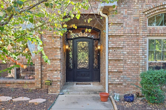 view of exterior entry with brick siding